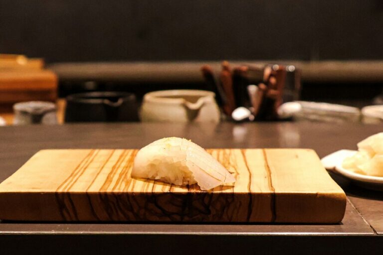 Omakase in Singapore : Close-up of sushi rice topped with fresh fish served by an omakase chef