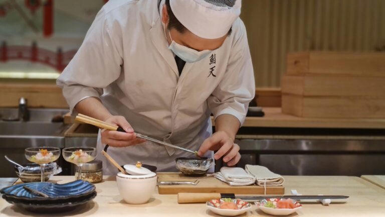 Japan Cuisine : A chef’s hand carefully plating sashimi, embodying tradition and innovation in harmony.