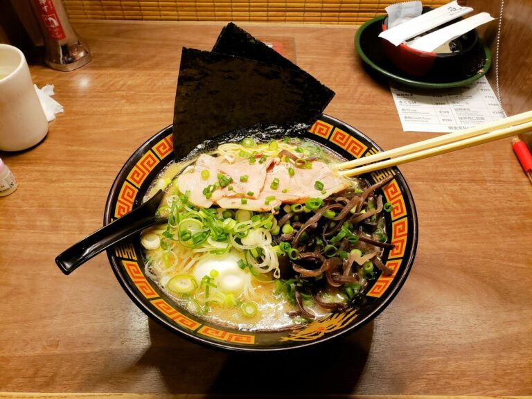 The image shows a vibrant ramen bowl with traditional toppings. This colorful dish exemplifies Japanese culinary mastery and offers a delightful dining experience for guests at a Japanese restaurant in Singapore.