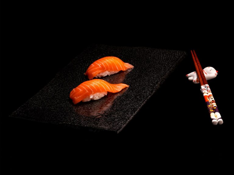 e Guide to Japanese Food : A pair of chopsticks neatly placed on a ceramic rest beside a traditional Japanese meal.