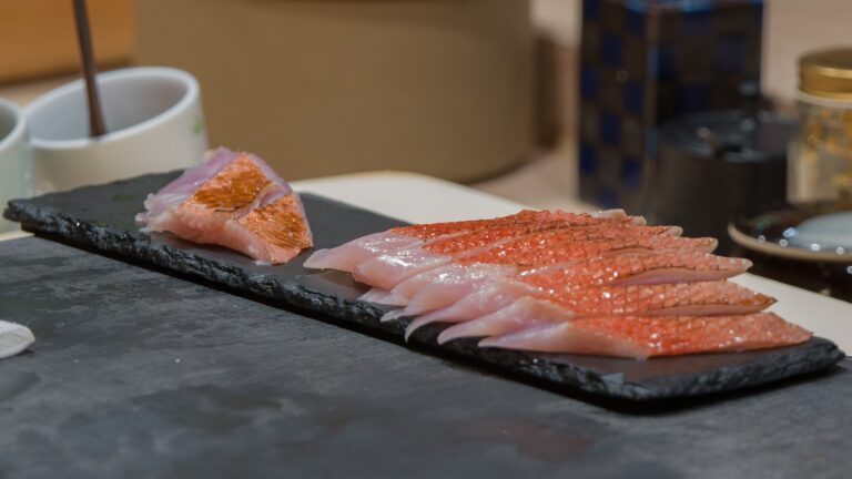 Fresh sashimi slices of premium fish, glistening with natural oils and beautifully presented