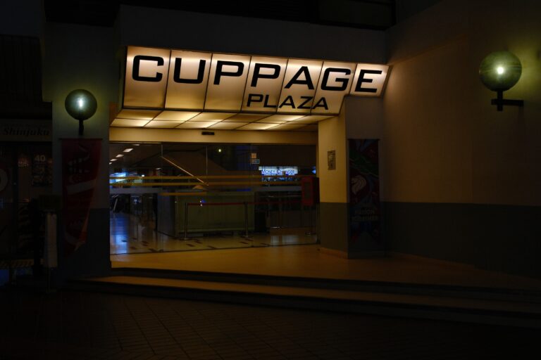 A wide-angle view of Cuppage Plaza’s exterior, capturing its iconic structure, illuminated signage, and bustling atmosphere in the heart of Singapore’s dining distric