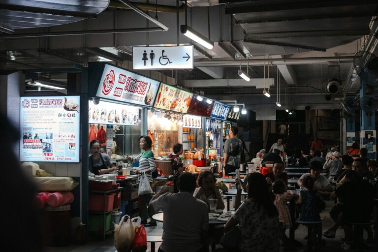 Japanese Food in SG : A bustling hawker centre in Singapore serving authentic Japanese cuisine, where locals enjoy ramen, donburi, and sushi in a lively open-air setting.