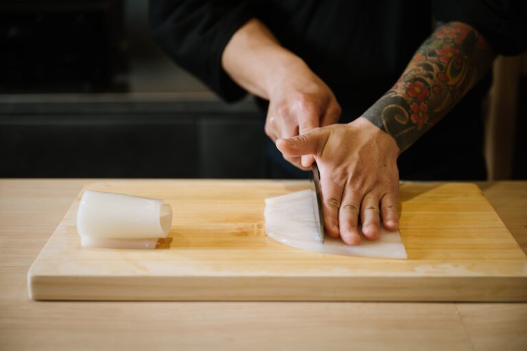 Close-up view of the chef’s skilled knife work at Sushi Masa, demonstrating expert technique and meticulous attention to detail in every slice of the fish.