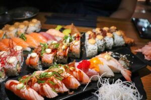 A vibrant assortment of sushi showcasing different types and textures, artfully arranged on a wooden platter.
