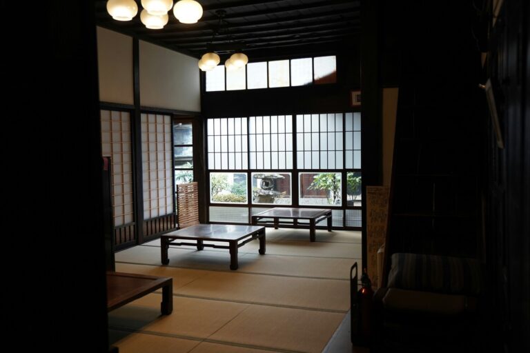 The image depicts the serene interior of a traditional Japanese restaurant, featuring elegant wooden furnishings and a peaceful ambiance that enhances the dining experience. Guests can enjoy a variety of signature dishes, including sushi and sashimi, in a refined setting that reflects the essence of Japanese cuisine.