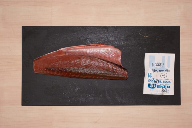 A close-up display of pristine fish meat slices freshly flown in from Japan, showcasing their glistening texture and rich colour that emphasise their exceptional freshness and premium origin.