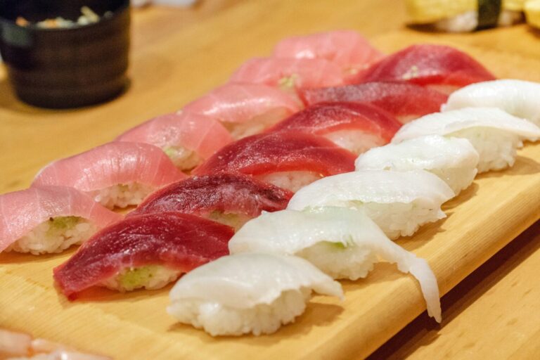 Japanese Food in SG : A beautifully plated sushi set displayed on a polished wooden counter, showcasing the craftsmanship and precision of traditional Japanese culinary art.