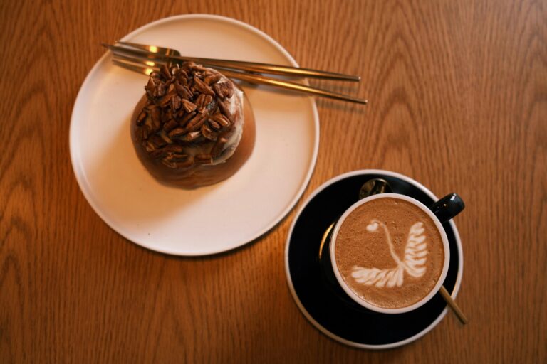 Restaurants in Singapore: A cosy café table set with a cup of freshly brewed coffee, toast, and eggs for a classic Singapore breakfast.