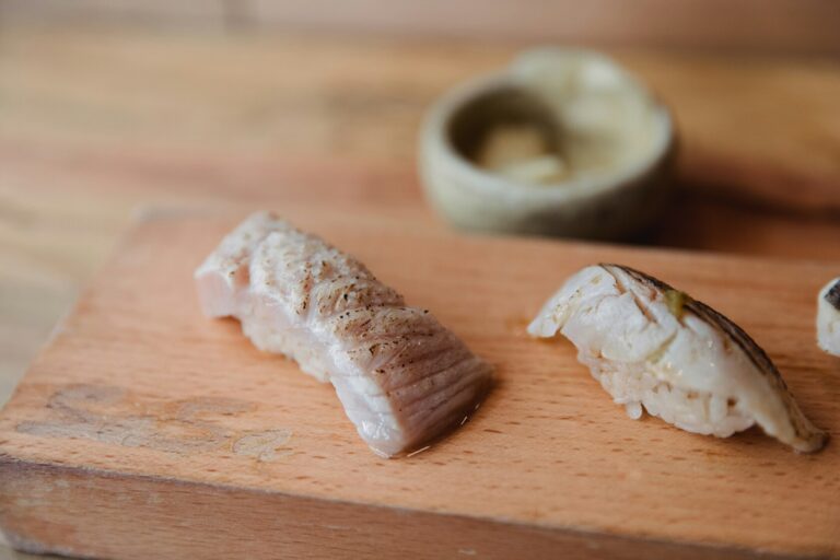Fresh sashimi sushi placed on a wooden table, highlighting the vibrant colours and delicate textures of the fish