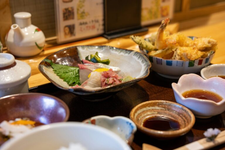 Japanese Food in SG : An assortment of Japanese set meals neatly presented on a wooden table, complete with rice, miso soup, and side dishes, reflecting everyday dining traditions.