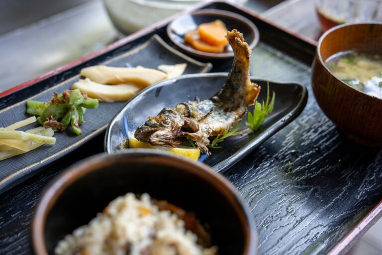 Japanese Food in SG : A wholesome Japanese meal featuring steamed rice, miso soup, grilled or fried fish, and small side dishes arranged in balanced harmony.