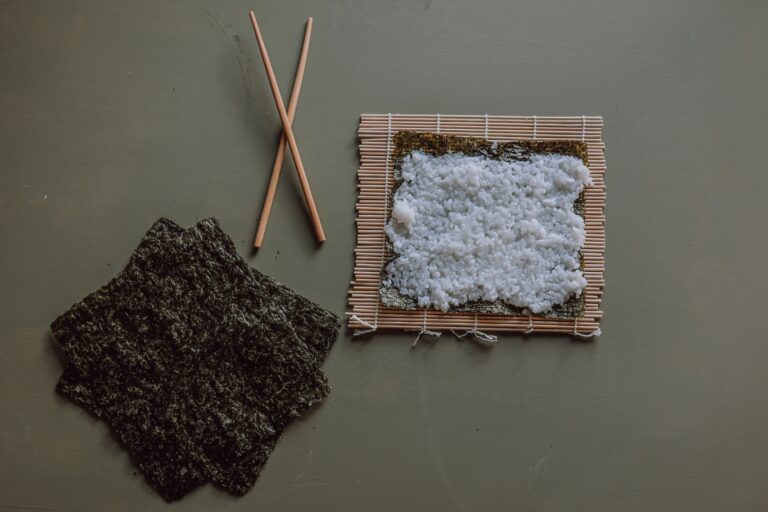 Japan Sushi: A close-up of glossy sushi rice wrapped in crisp seaweed, capturing the simplicity and balance of traditional Japanese preparation.
