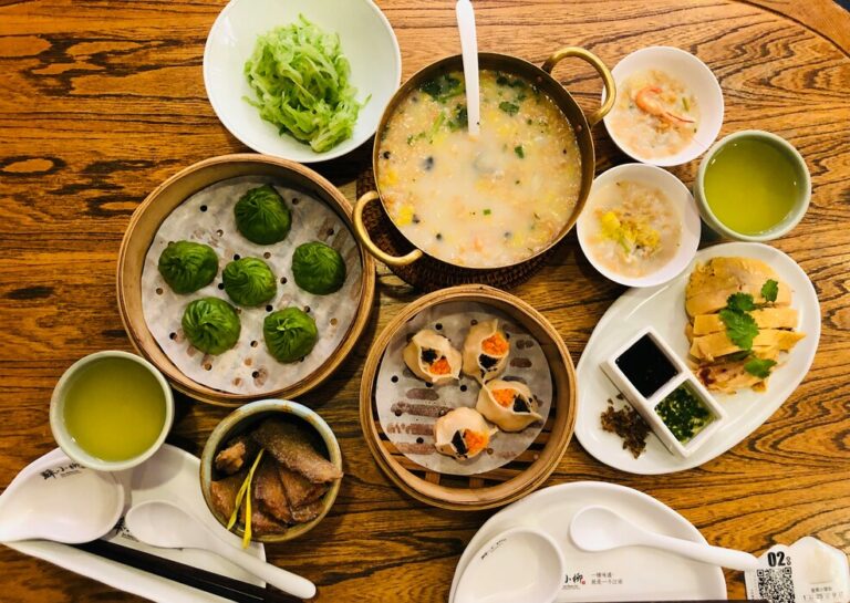 Restaurants in Singapore: A vibrant Chinese restaurant table filled with steaming baskets of dim sum, showcasing traditional Cantonese dining culture.