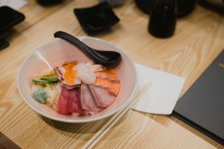 An elegant display of seasonal Japanese ingredients showcases fresh fish and vibrant vegetables, reflecting the artistry of refined dishes. This culinary adventure highlights the use of the finest ingredients, inviting diners to experience authentic flavors in a tranquil atmosphere.