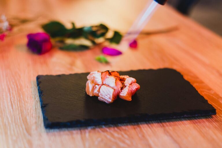 Freshly sliced fish is gently torched with a handheld burner, allowing the surface to caramelise while releasing delicate aromas and natural oils.