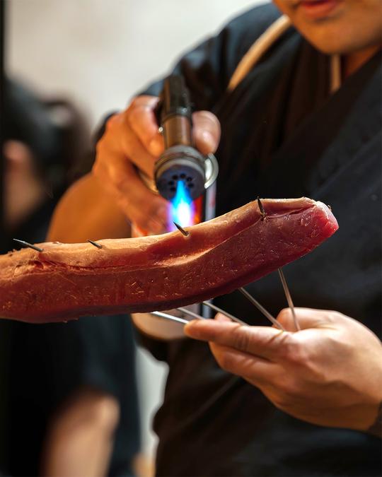 Chef Masa expertly torches the fish, creating a smoky, melt-in-the-mouth finish that highlights the artistry of modern omakase.