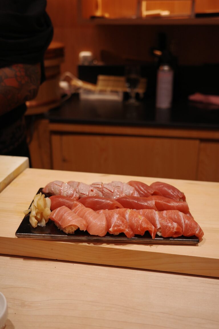 The image showcases a beautifully arranged selection of seasonal Japanese ingredients, highlighting fresh seafood like sea urchin and scallops, alongside vibrant vegetables, all presented for an exquisite omakase dining experience. This artful display exemplifies the finest ingredients typically found in a lunch omakase menu at a high-end omakase restaurant.