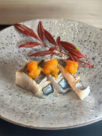 A premium fish course presented in elegant Japanese tableware, showcasing fresh texture, precise cuts, and elevated omakase flavours.