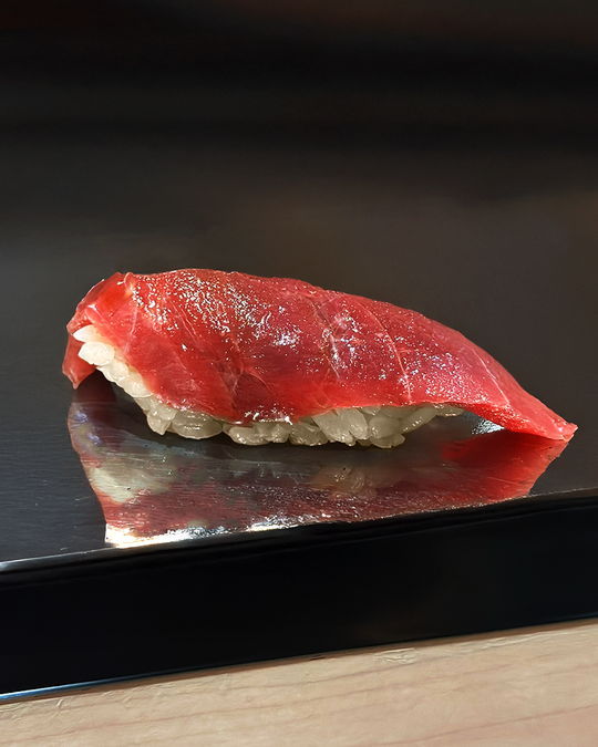 A meticulously crafted piece of sushi resting on an elegant plate, highlighting refined knife work, premium ingredients, and the understated beauty of Japanese cuisine.