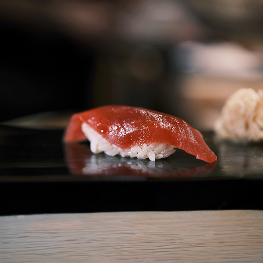 A piece of Edomae-style sushi prepared with traditional techniques, celebrating time-honoured methods of curing, marinating, and enhancing natural flavours.