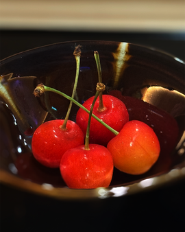 A delicate dessert topped with a bright red cherry, providing a sweet and visually striking conclusion to the dining experience.