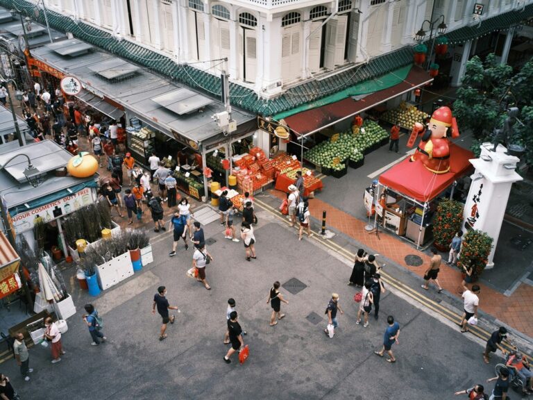 A bustling Singapore hawker stall offering a variety of local dishes, capturing the lively atmosphere, colourful food displays, and authentic street-side flavours.