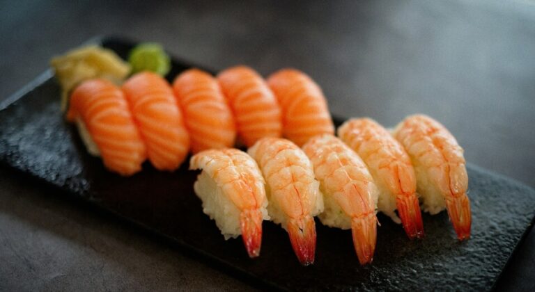 Sushi piece placed on the table, emphasising its clean form, fresh topping, and refined simplicity.