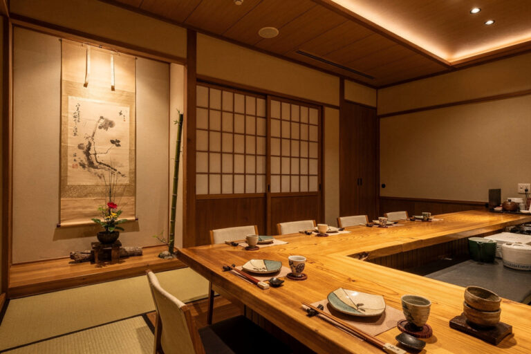 A luxurious Japanese private dining room featuring dramatic lighting and refined decor, creating an intimate and elevated omakase experience.
