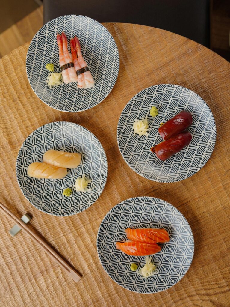 A selection of assorted sushi types arranged neatly on the table, showcasing different colours, textures, and ingredients