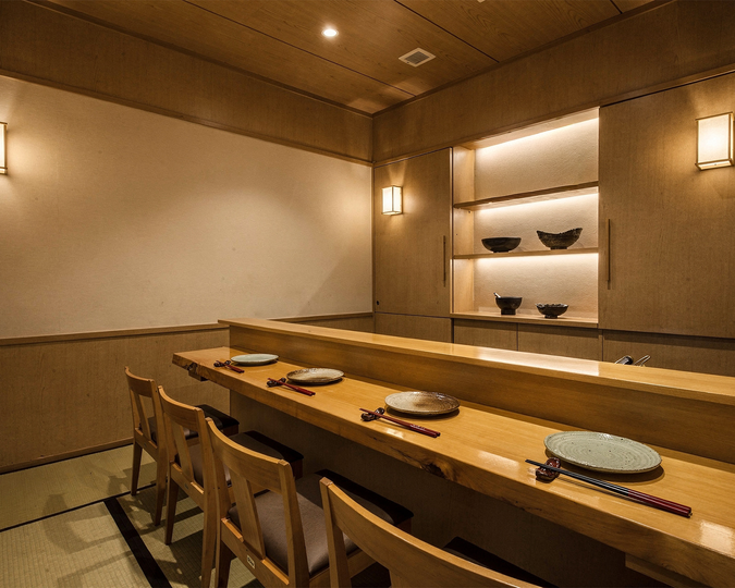 A serene Japanese restaurant featuring an intimate private dining room, designed with warm wood tones and minimalist décor for a refined and exclusive dining experience.