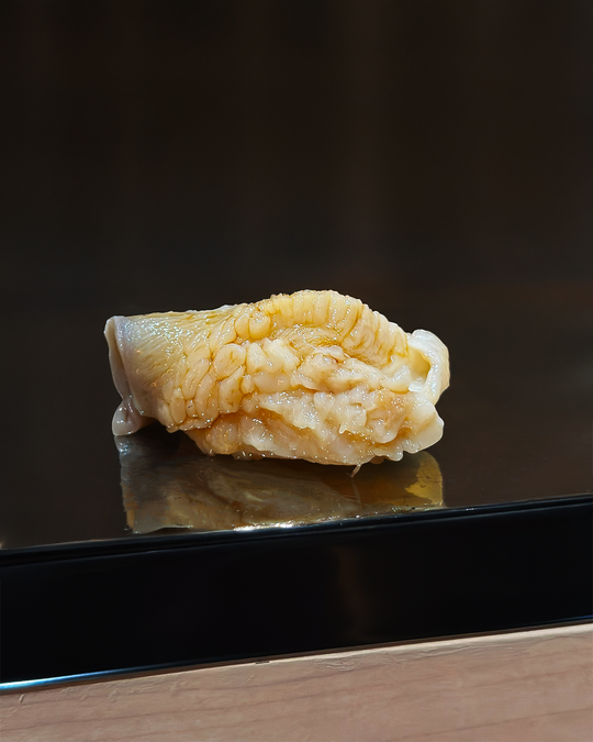 A carefully composed omakase sushi course highlighting contrasting textures—from silky fish to gently seasoned rice—demonstrating the balance and craftsmanship behind traditional Japanese sushi.