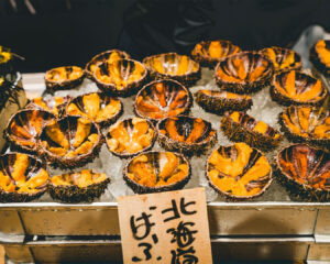 Fresh bafun uni displayed neatly at a Japanese seafood market, showing its golden colour and premium quality.