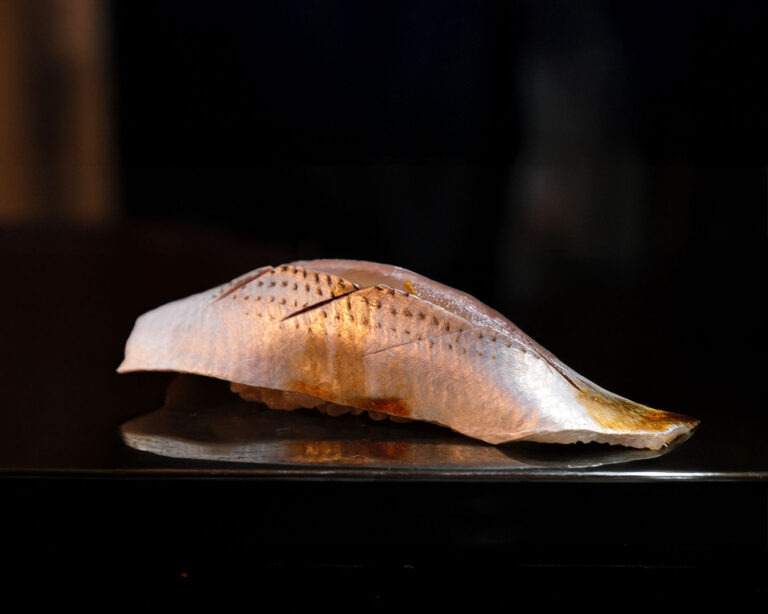A plate of Edomae-style sushi arranged neatly, displaying fresh fish and traditional technique.