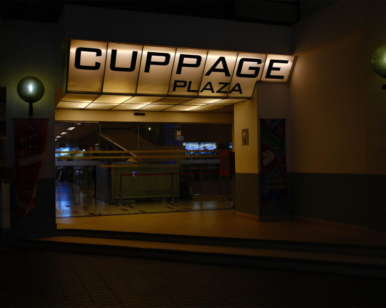 Exterior view of Cuppage Plaza, showing the building façade and surrounding street, marking the location of the restaurant within Singapore’s city dining district.