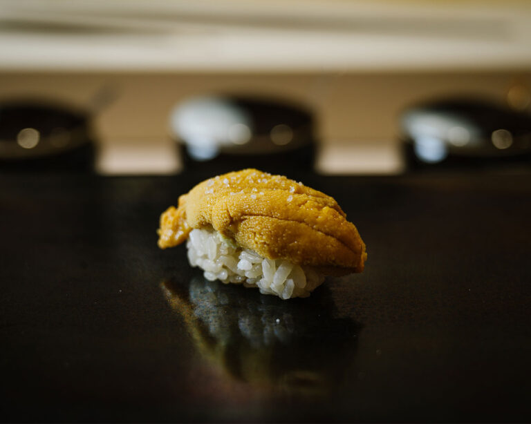 A plate of sea urchin sushi topped with creamy uni, presented with clean and elegant plating.